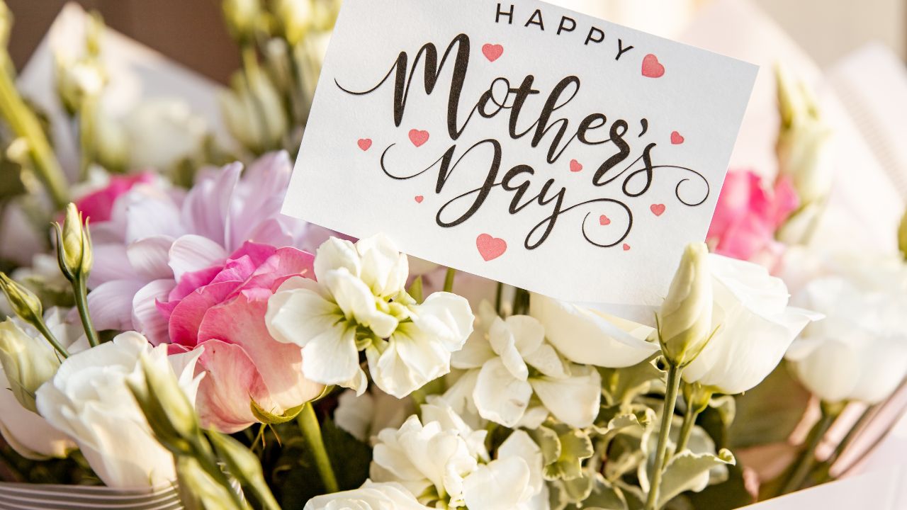A bouquet of pink and white flowers with a "Mother's Day" card.