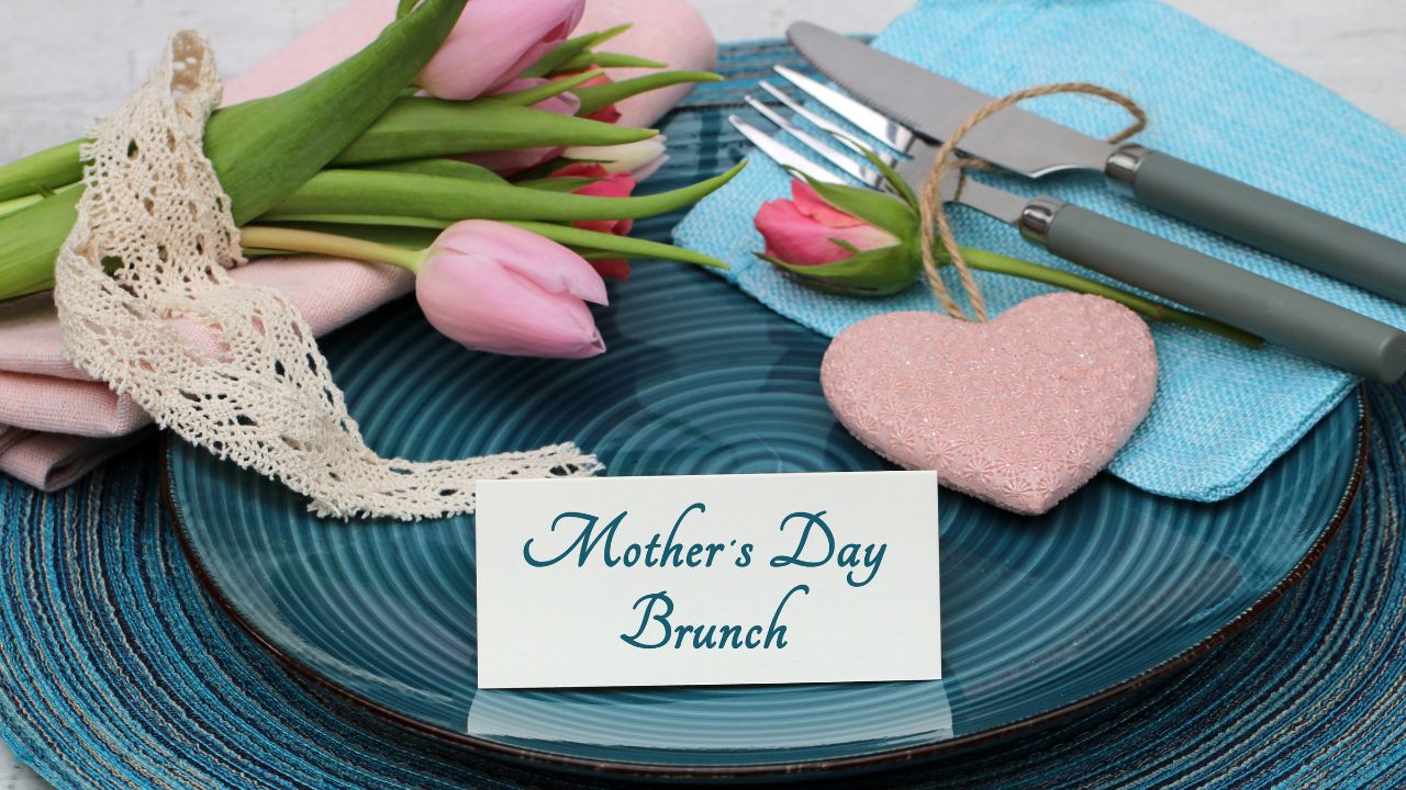 A brunch setting with tulips and a “Mother’s Day Brunch” card.