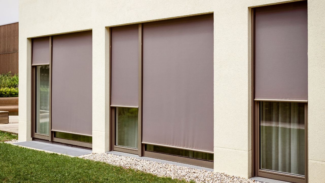 Modern house exterior with closed shutters on windows.