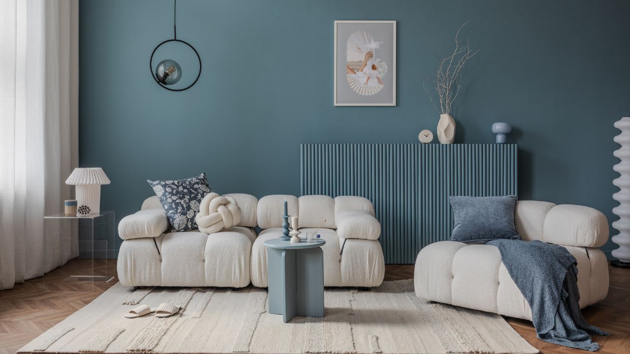 Cozy living room with a beige sofa, blue walls, and modern decor.