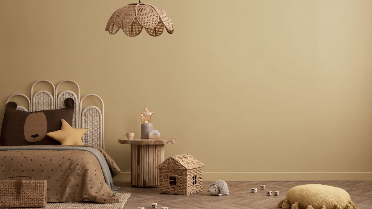A children's room with a bed decorated like a bear, toys, and a star-shaped pillow.