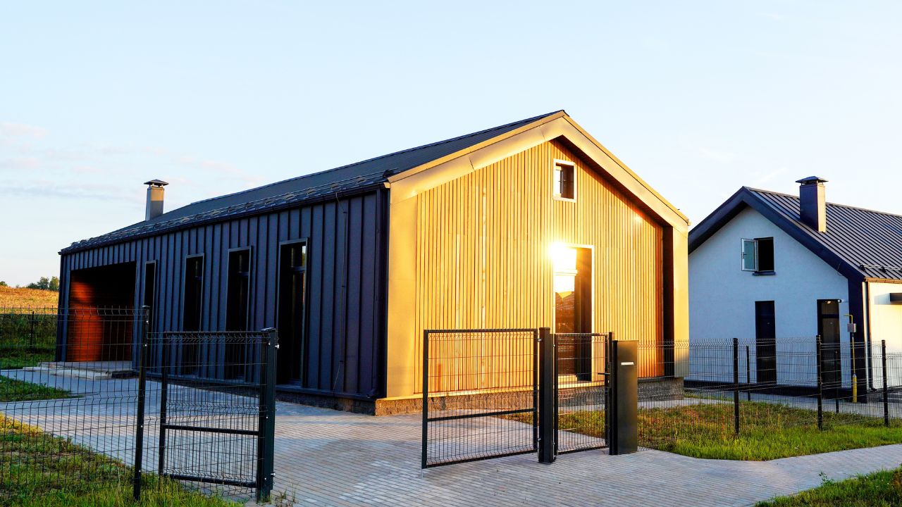 Contemporary barn house with a warm glow from the setting sun.