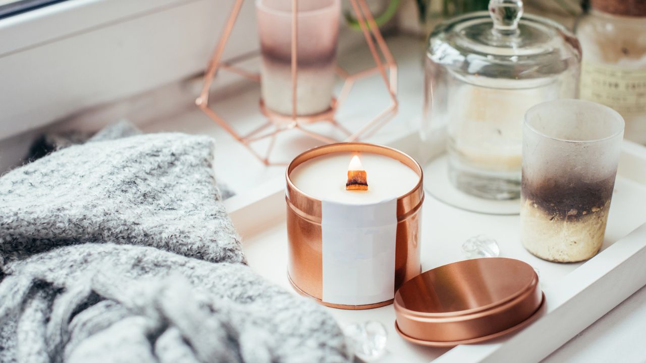 Cozy table setting with candles and decorative objects.
