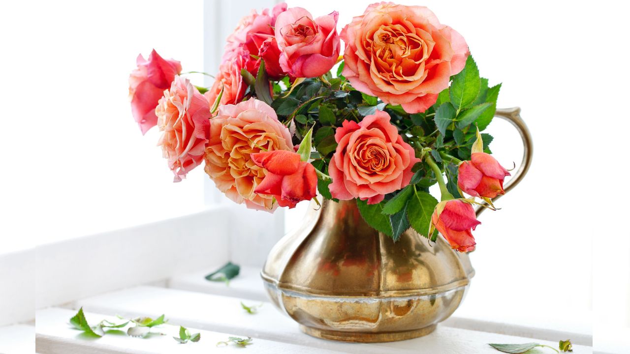 Elegant table with rose gold and white dinnerware and flowers.