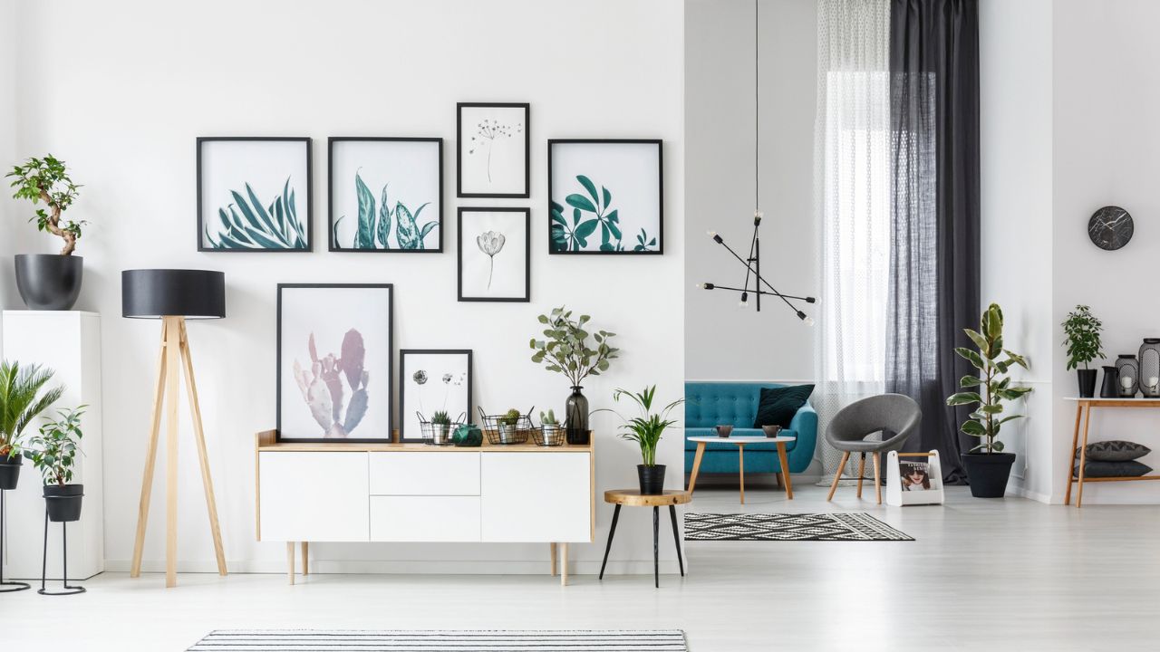 A stylish hallway with a gallery wall of framed artwork, potted plants, and modern furniture.