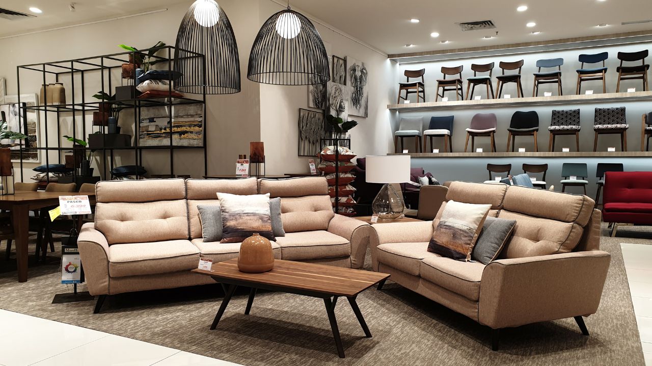 A cozy living room setup with a beige sectional sofa, a coffee table, and decorative pillows.