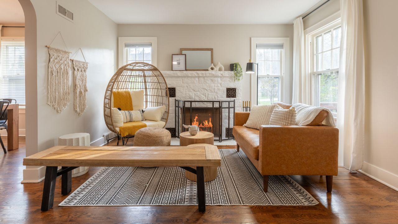 Cozy living room with a fireplace, featuring a yellow cushioned chair and neutral-toned accents.