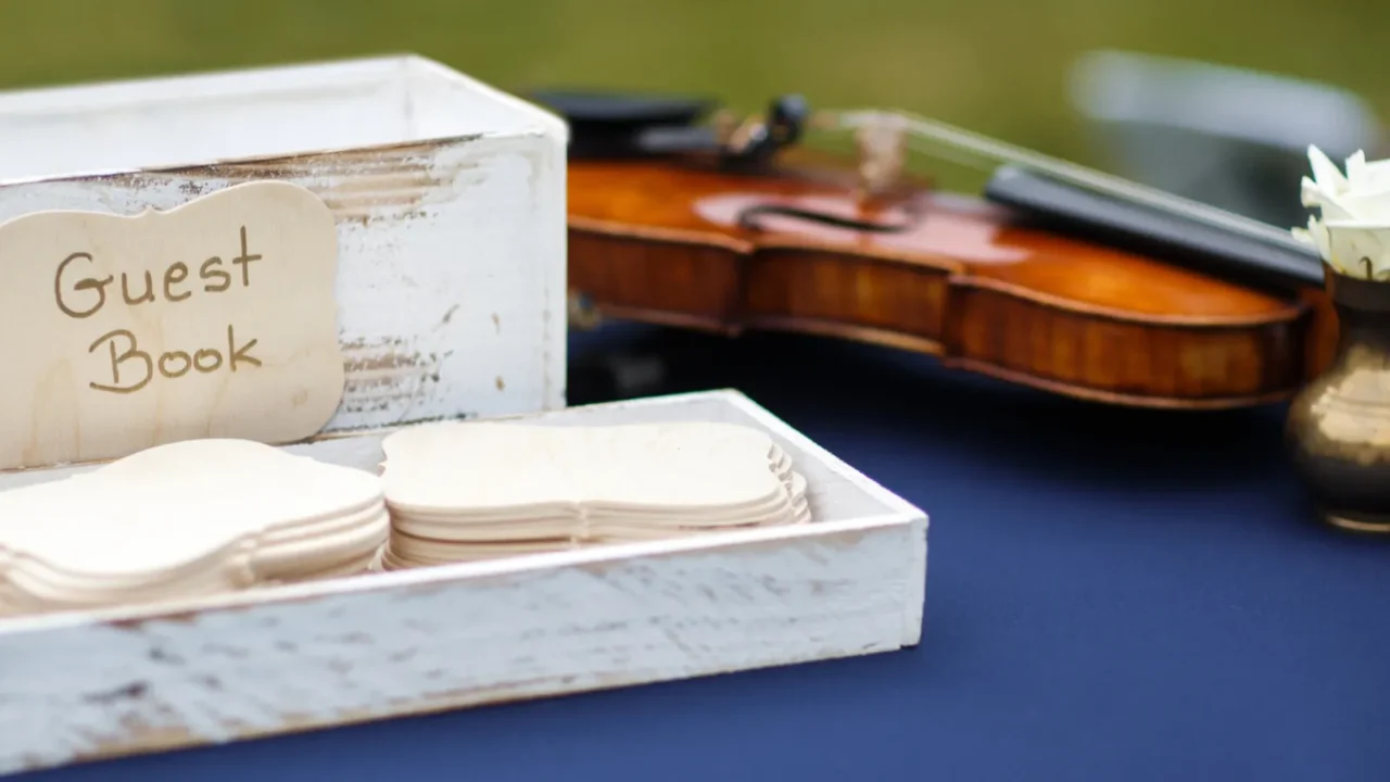 close up of wedding guest book and violin on the