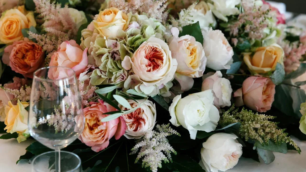 dinner table decorated with rich pink and white roses and