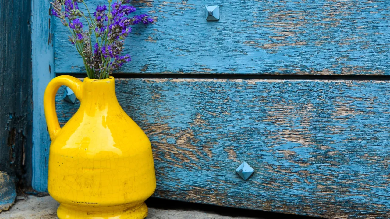 lavender in a yellow vase on a background of blue
