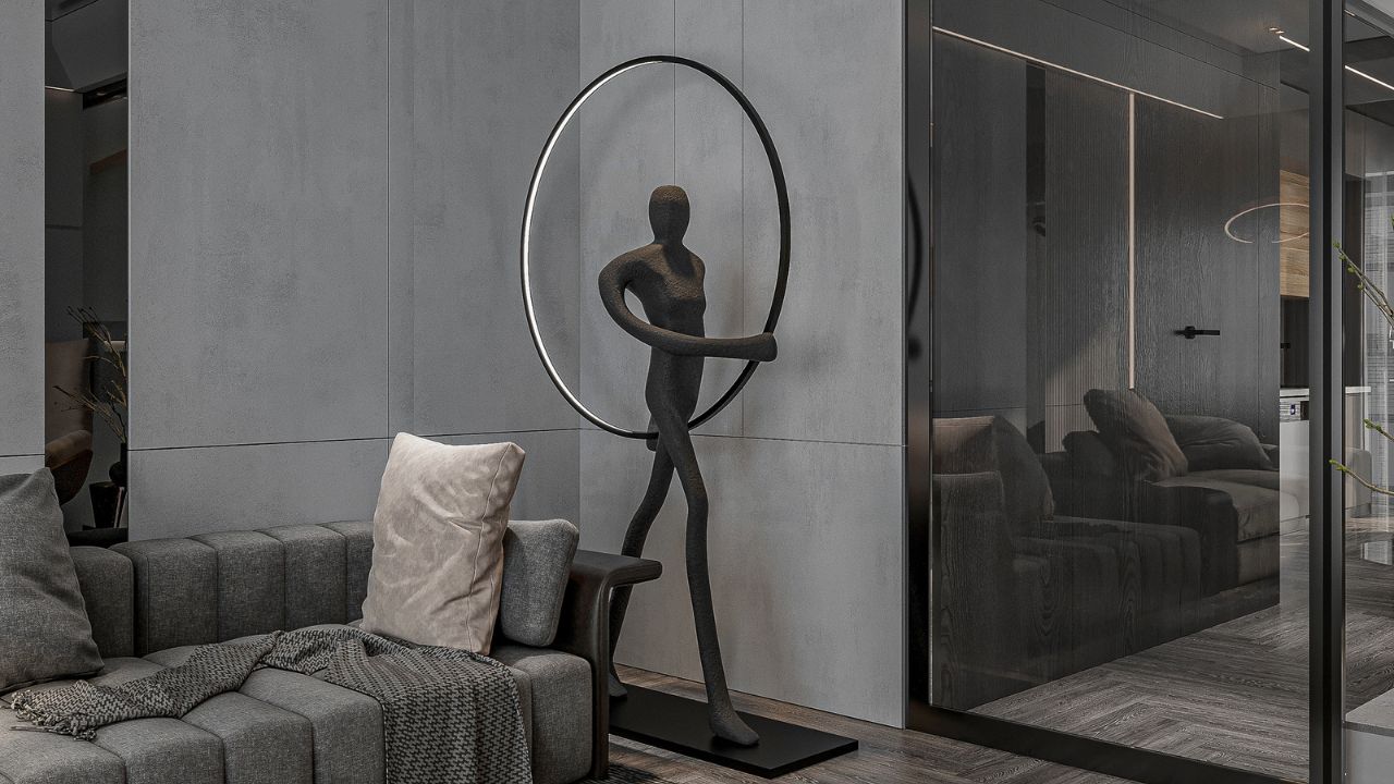 Modern sculpture of a woman with a circular frame, placed in a living room corner.
