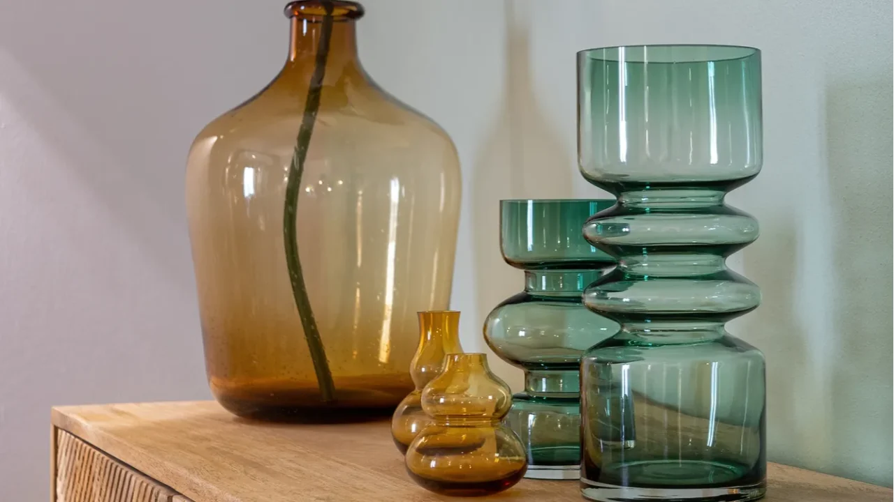 transparent yellow and green vases for flowers and big bottle