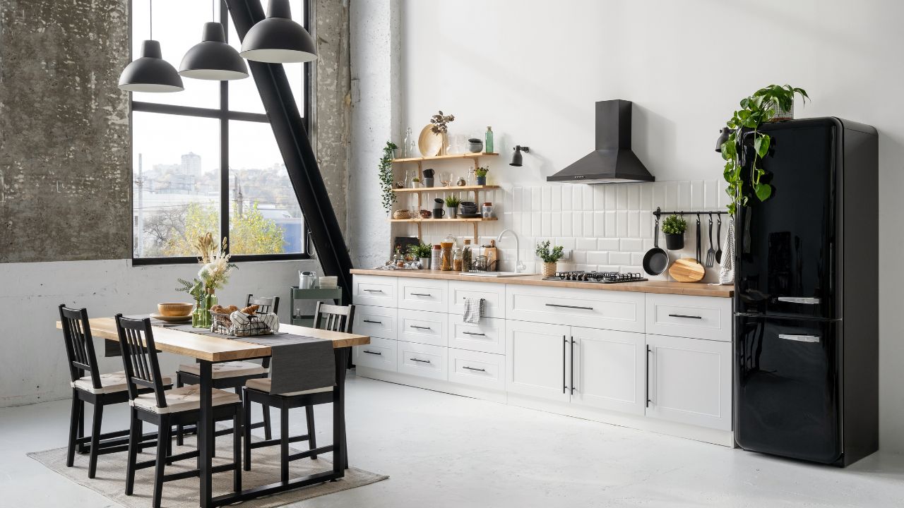 Modern kitchen with black and white decor and large window.