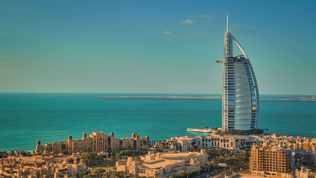 The iconic, futuristic Burj Al Arab hotel on the Dubai coast with its sail-shaped design.