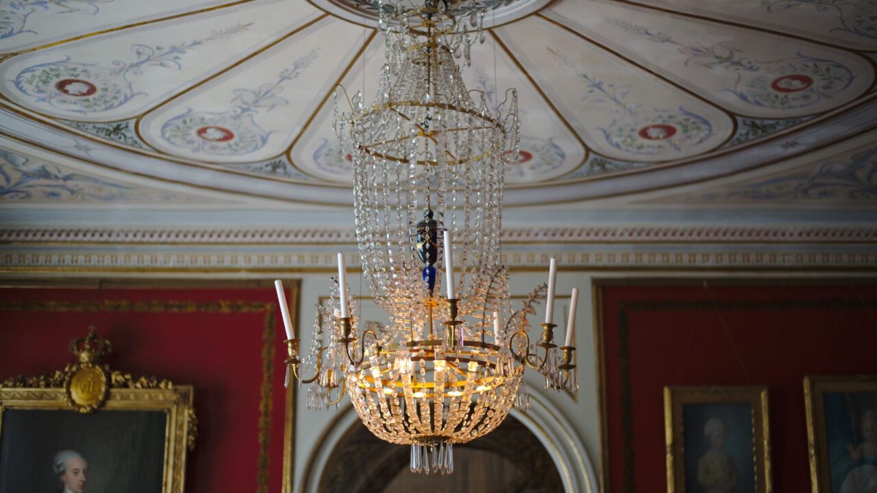 An ornate interior with a chandelier and rich decorations.
