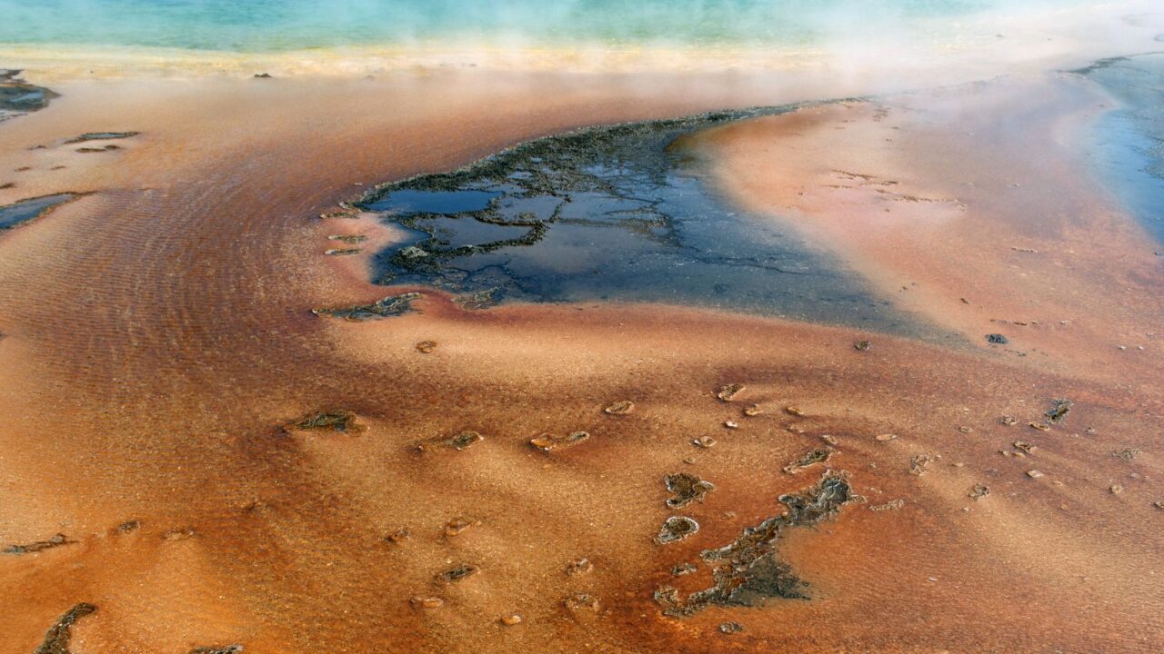 A striking aerial view of Yellowstone’s lava layers in Wyoming, showcasing rugged volcanic formations.