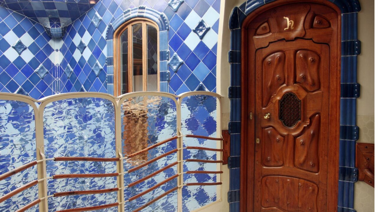 Detail of door present in casa batllo and blue tiles.