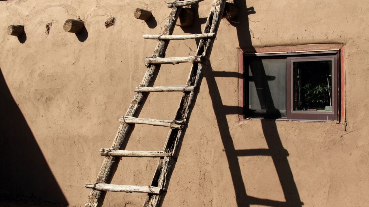 Southwestern ladder leaning against adobe wall in Taos Pueblo, New Mexico