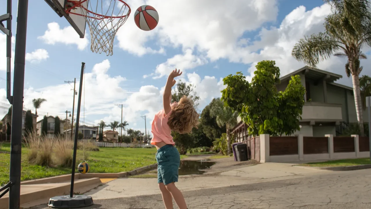 cute little boy child jumping with basket ball for shot