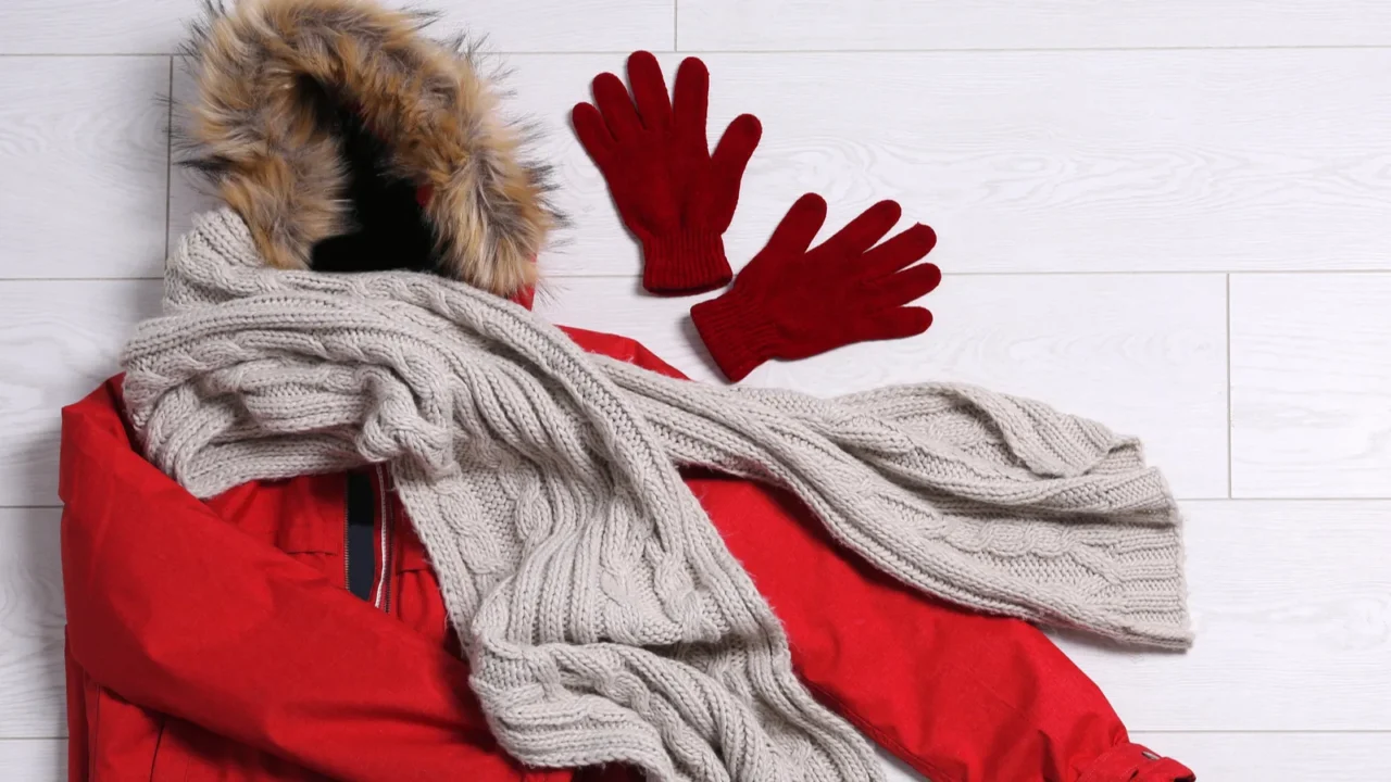 flat lay composition with warm clothes for winter vacation on