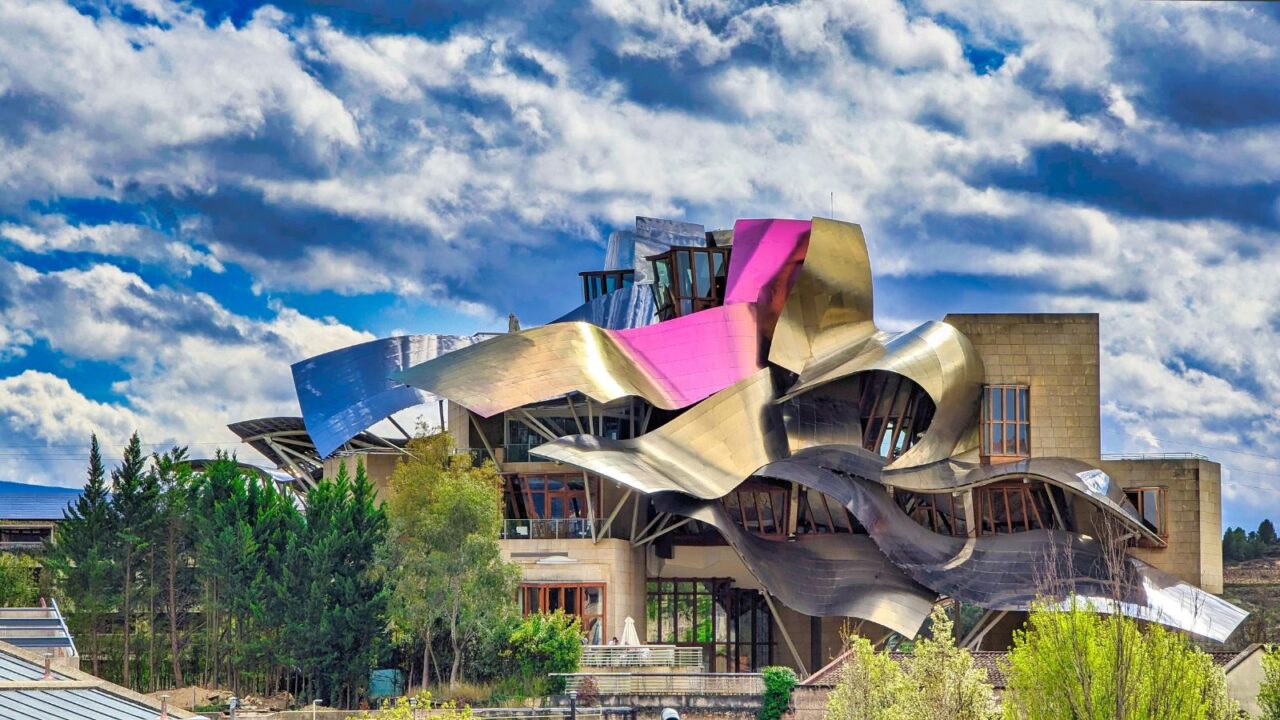 The unique, flowing architecture of Hotel Marqués de Riscal in Elciego, Spain, with its metallic and colorful design.