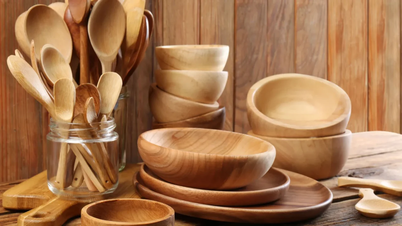 many different wooden dishware and utensils on table