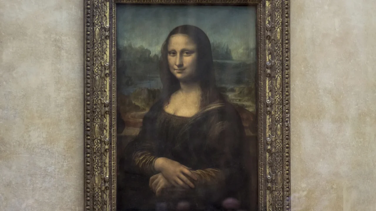 Framed Mona Lisa painting with the iconic smiling figure set against a muted landscape and beige wall backdrop.