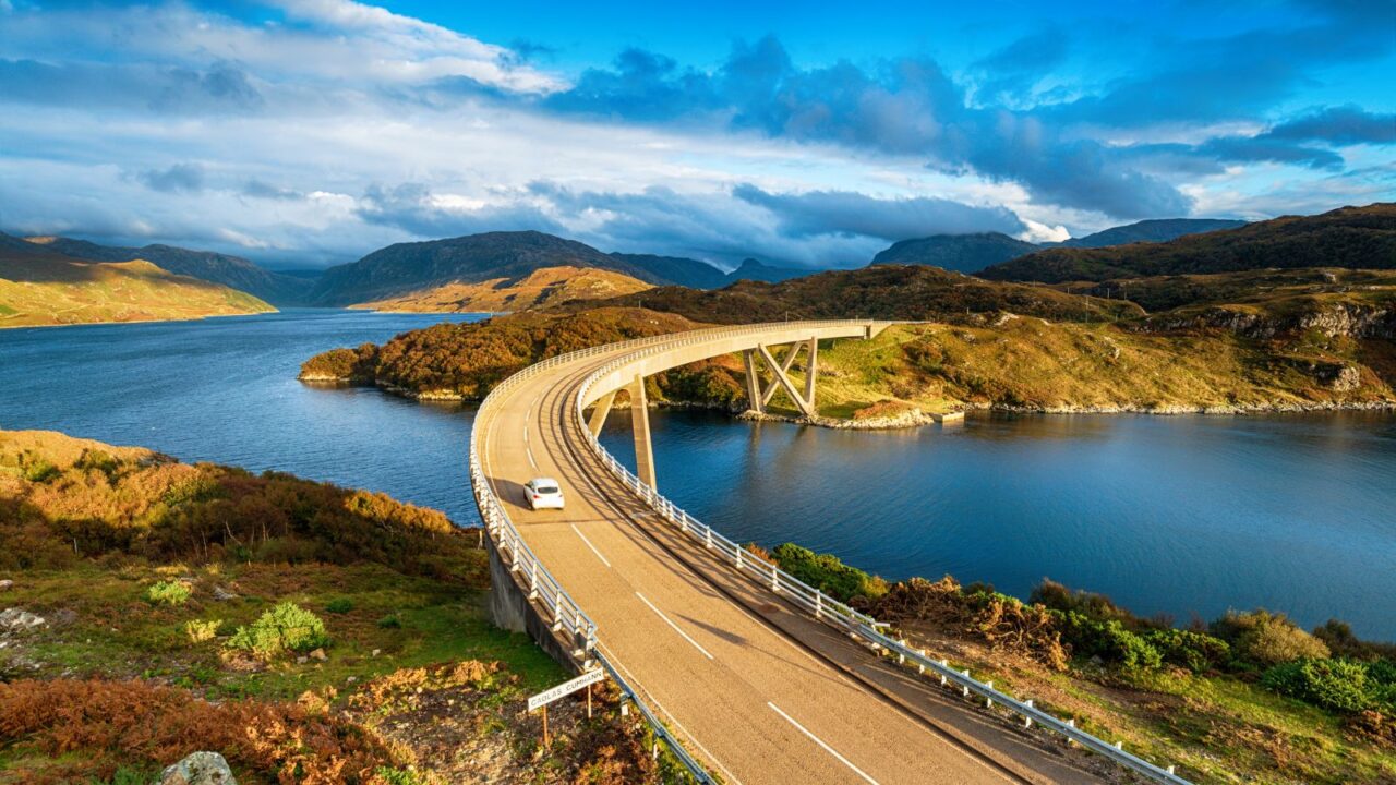 The Kylesku Bridge spanning Loch a' ChÃ irn BhÃ in in the Scottish Highlands and a landmark on the North Coast 500 tourist driving route.