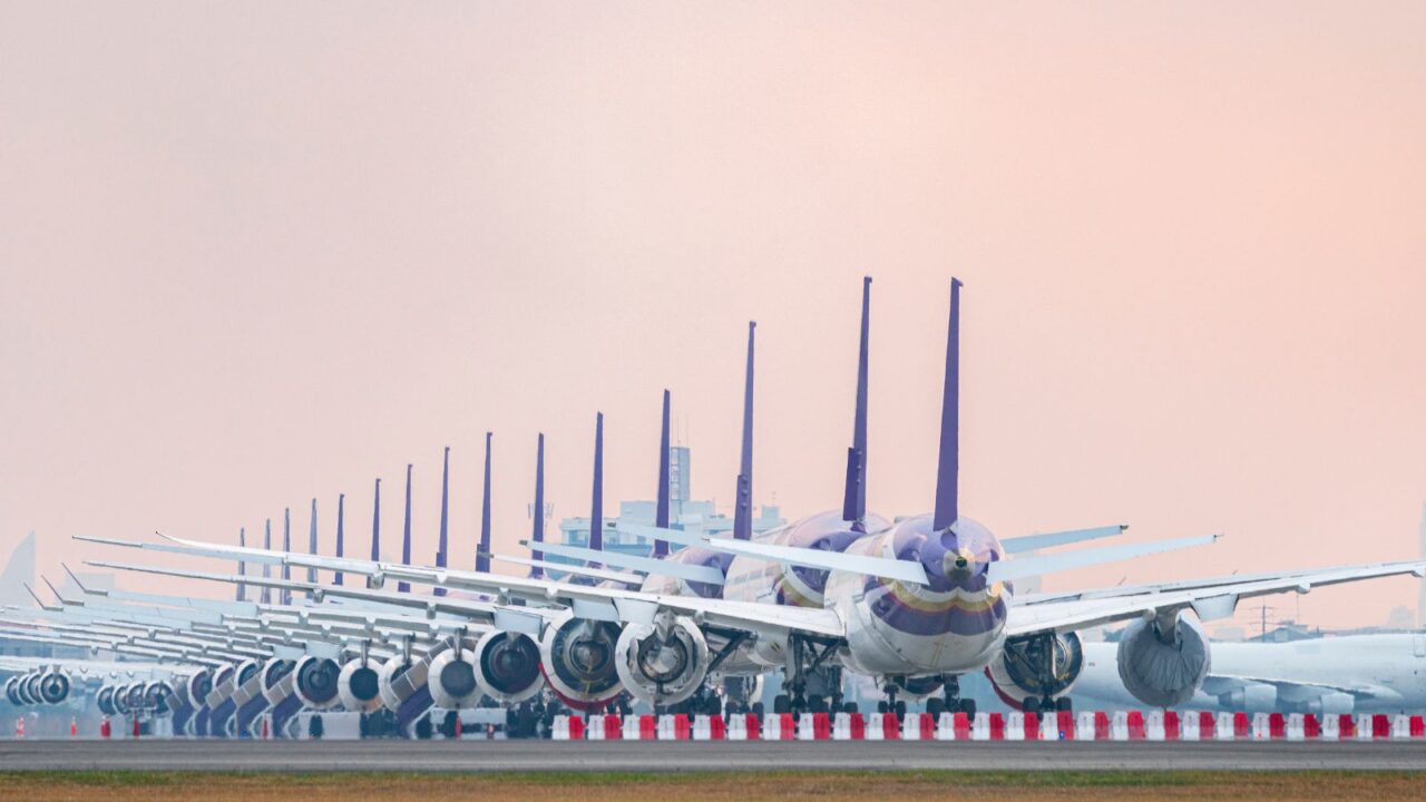 Aircraft parking at airport runway because of COVID-19 pandemic outbreak make airline stop operation.
