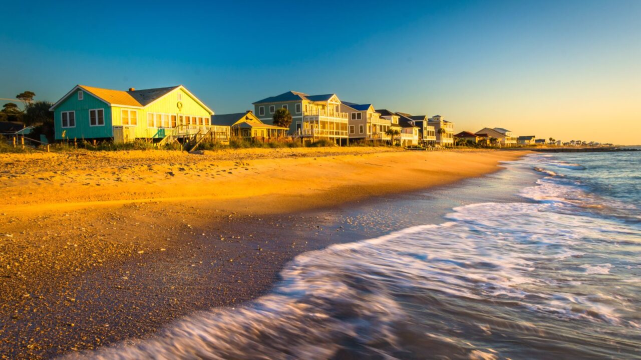 Waves in the Atlantic Ocean and morning light on beachfront homes at Edisto Beach, South Carolina.