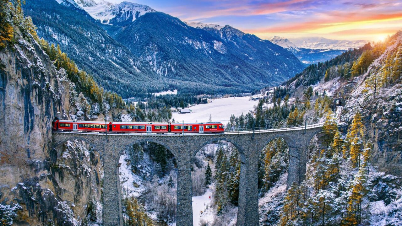 Aerial view of train passing through famous mountain in Filisur, Switzerland.