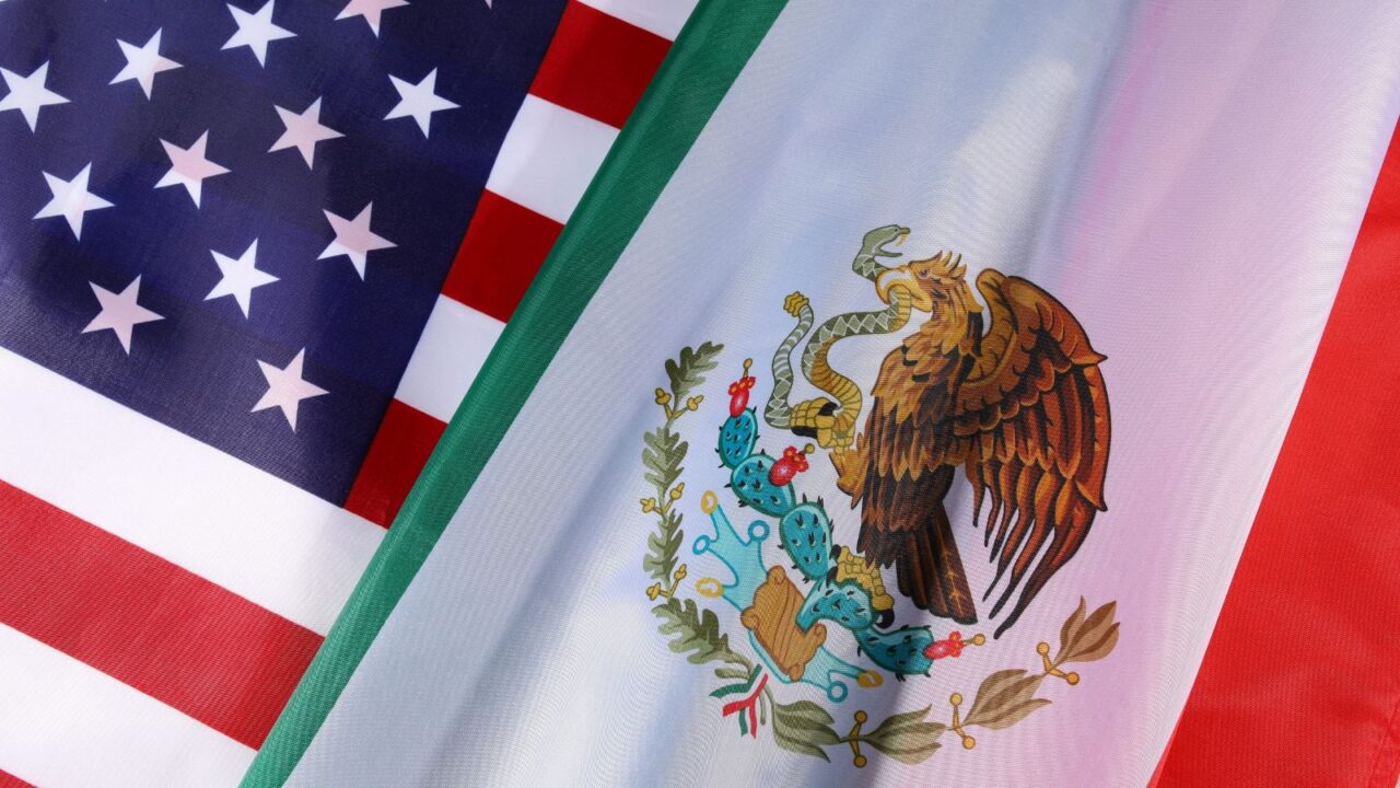 Flags of Mexico and the U.S. shown at a civic event..