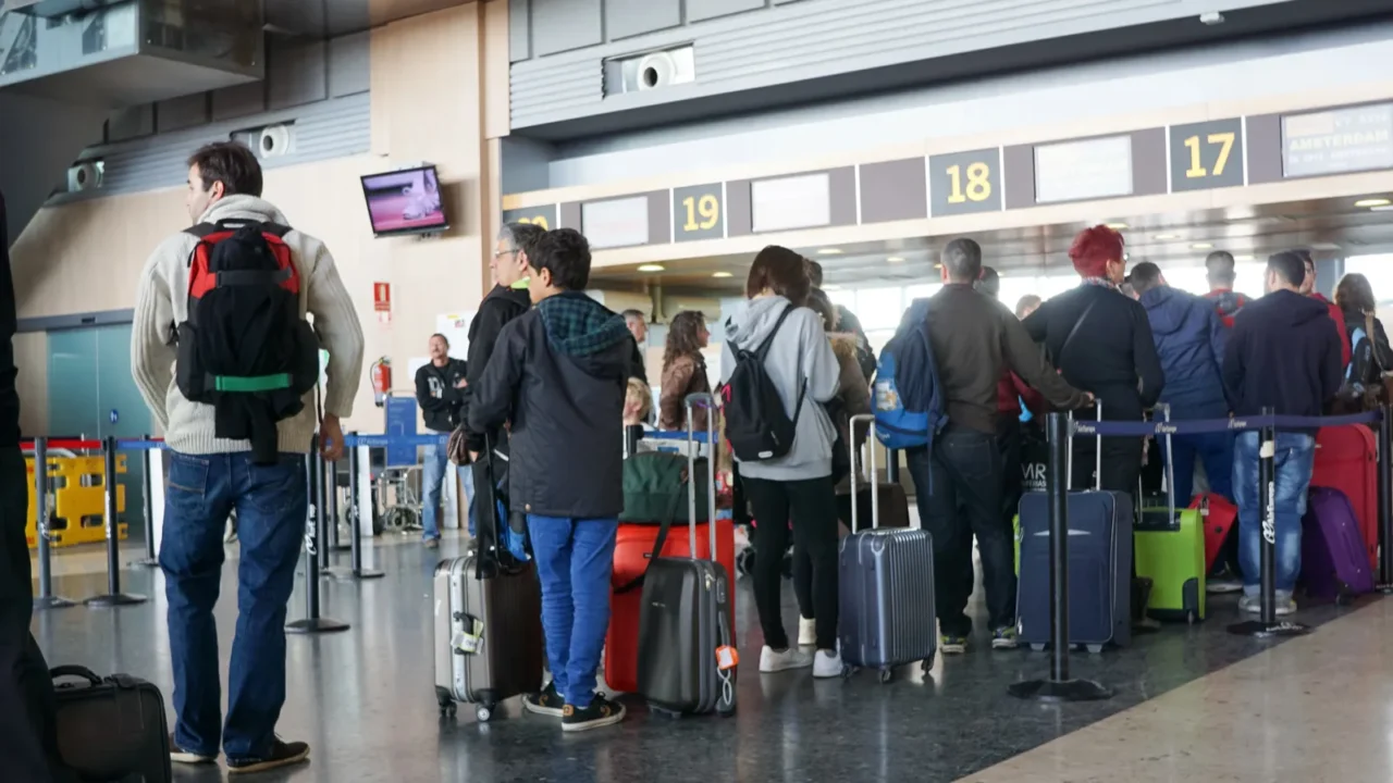 Airline passengers queued at the departure gates.