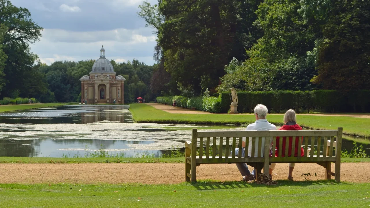 couple on bench looking at the thomas archer pavilion wrest
