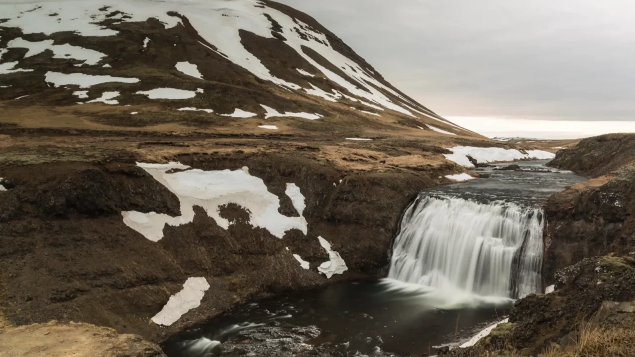 iceland landscape with waterfall in winter