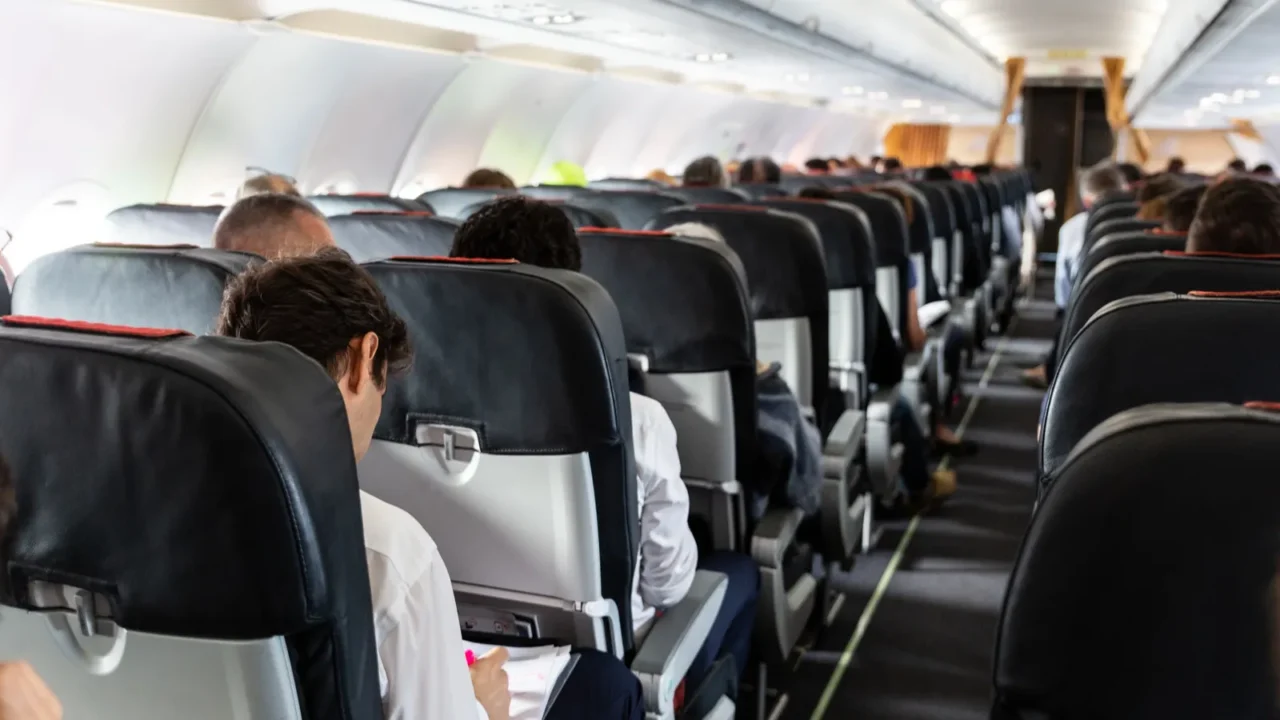 interior of large commercial airplane with passengers on their seats