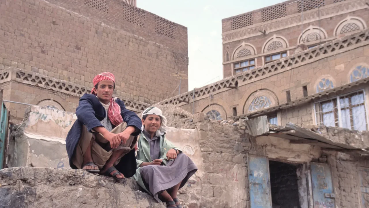sanaa yemenapril 252011 two men sitting on a rock in