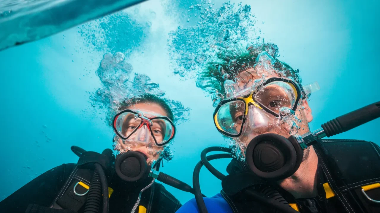 split photography of safari yacht woman and man diver exploring