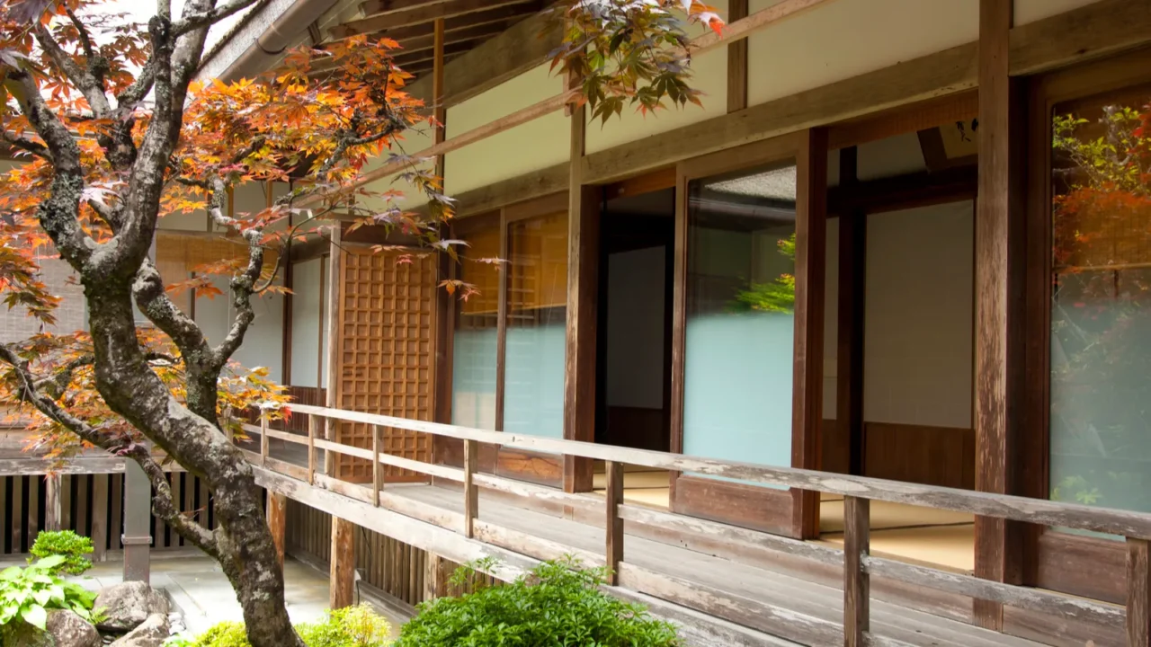 tranquil japanese garden with traditional architecture amidst vibrant autumn foliage