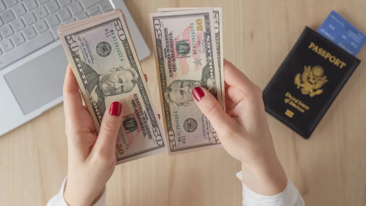 woman hold banknote 50 us dollars in hand and count
