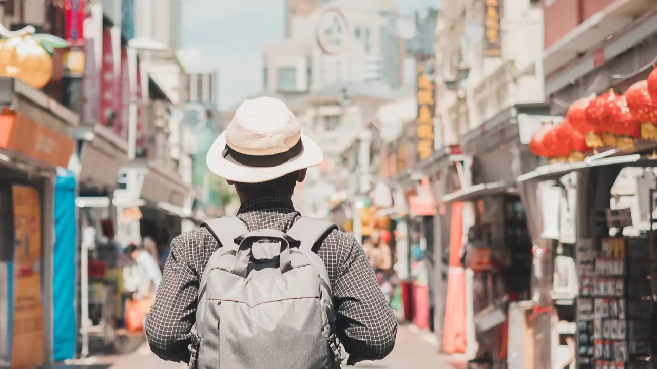 young man hipster traveling with backpack and hat happy solo