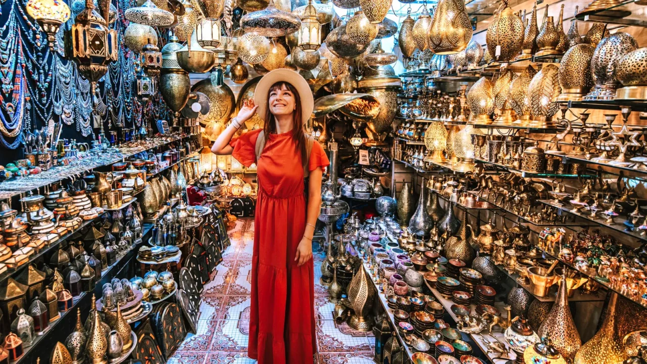 young traveling woman visiting a copper souvenir handicraft shop in