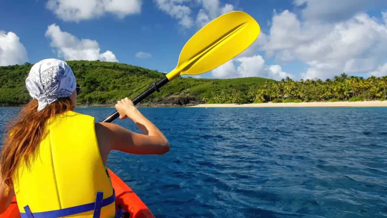 young woman kayaking near drawaqa island in yasawas fiji the