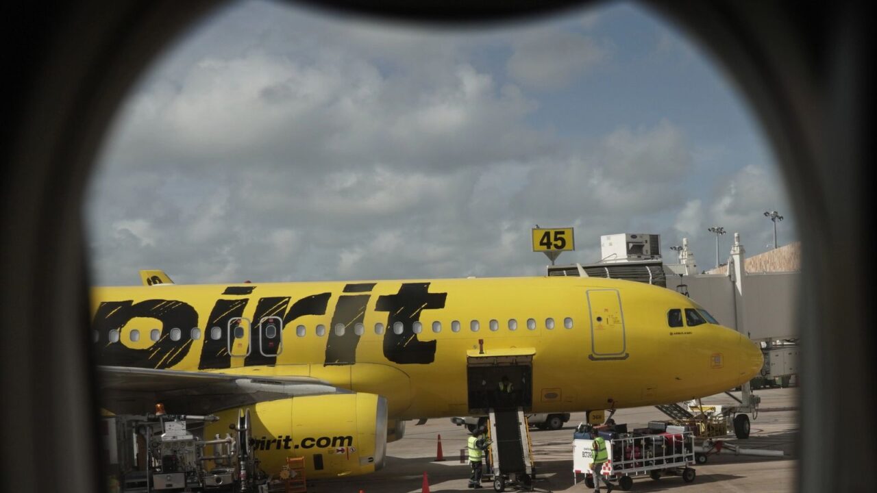 Spirit Airlines aircraft on the tarmac at Cancun International Airport.