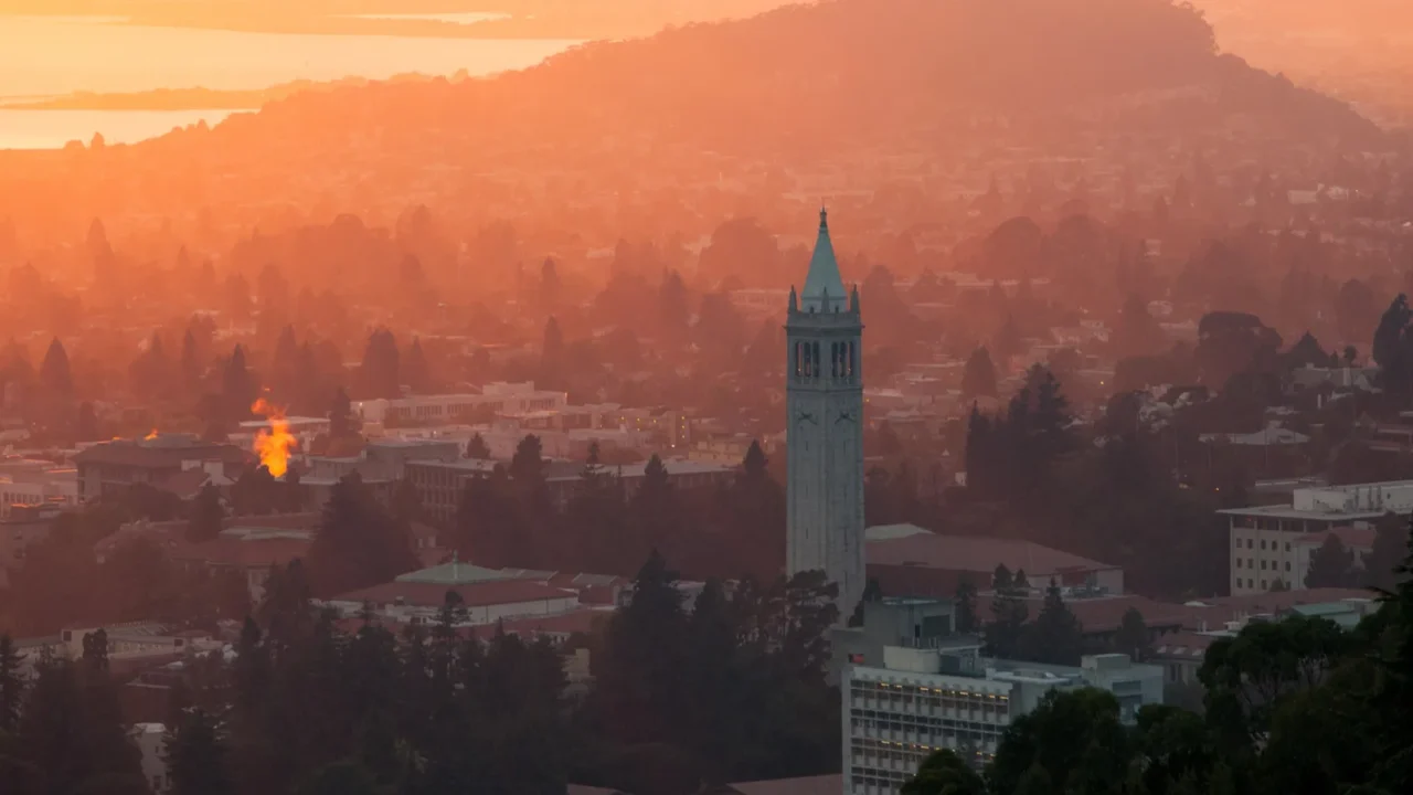 a beautiful sunset occurs over the city and campus of