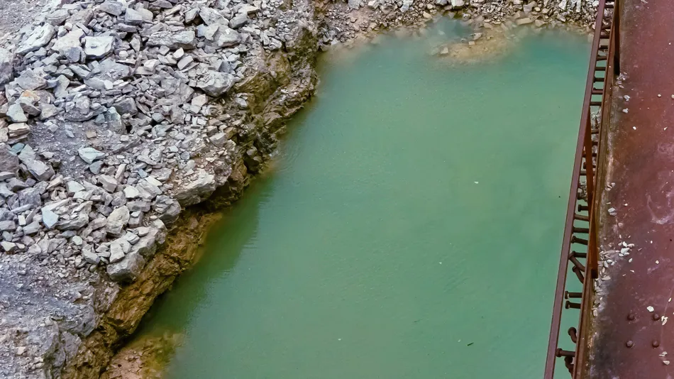 a massive puddle stands below a very old platform covered