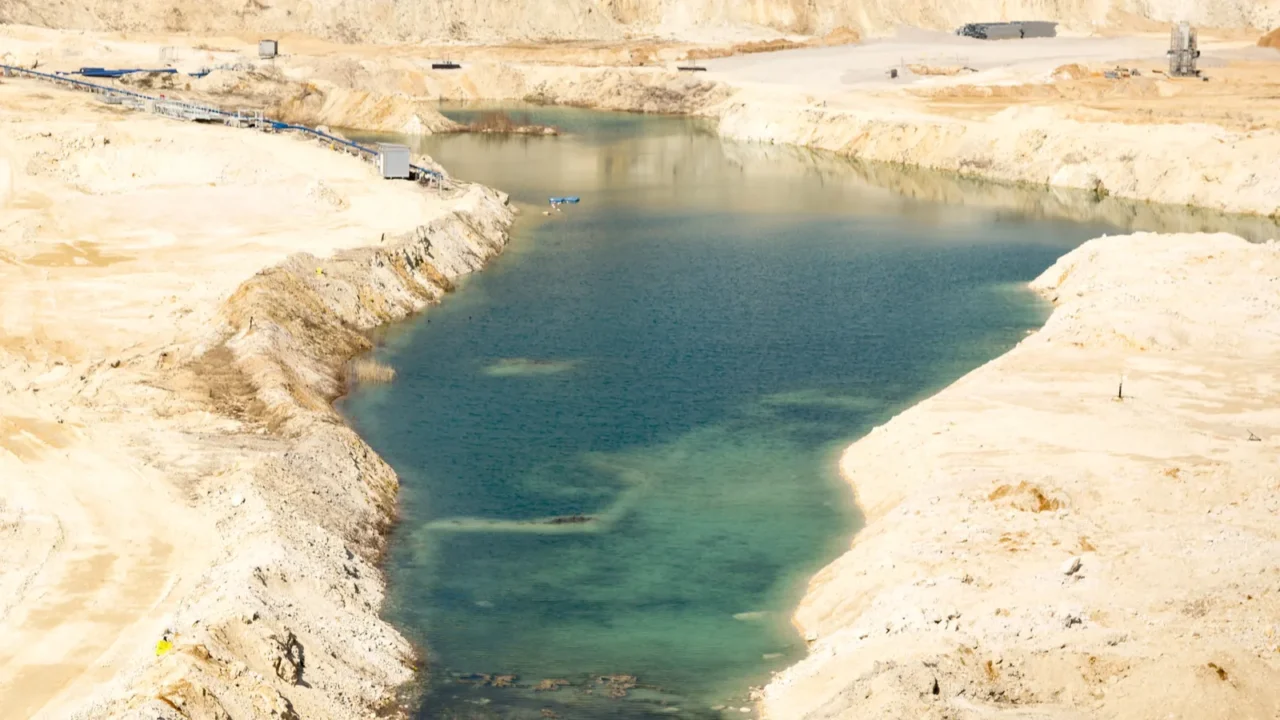 aerial view of an opencast sand gravel mine with pond