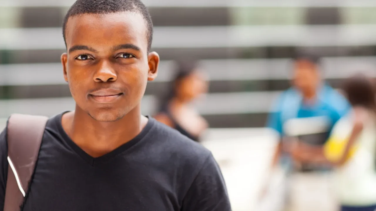 african college boy standing outdoors