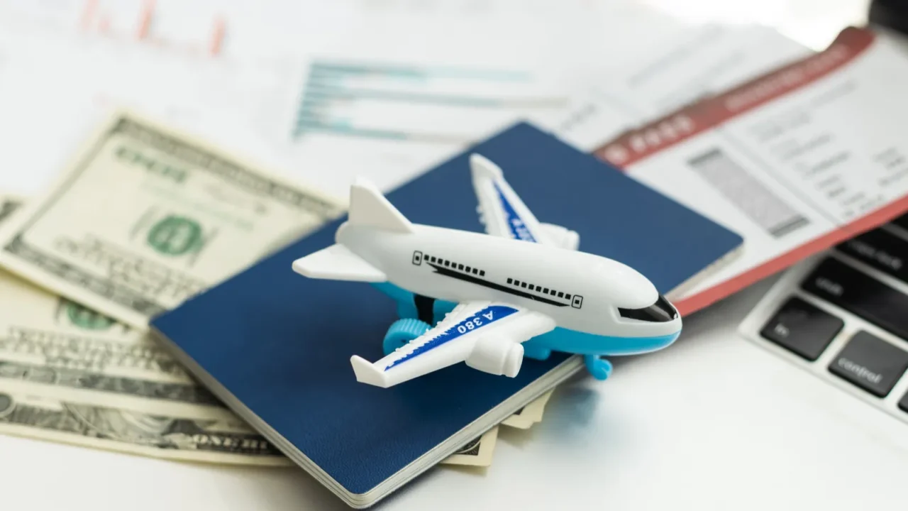 air tickets passports money and toy plane on table high