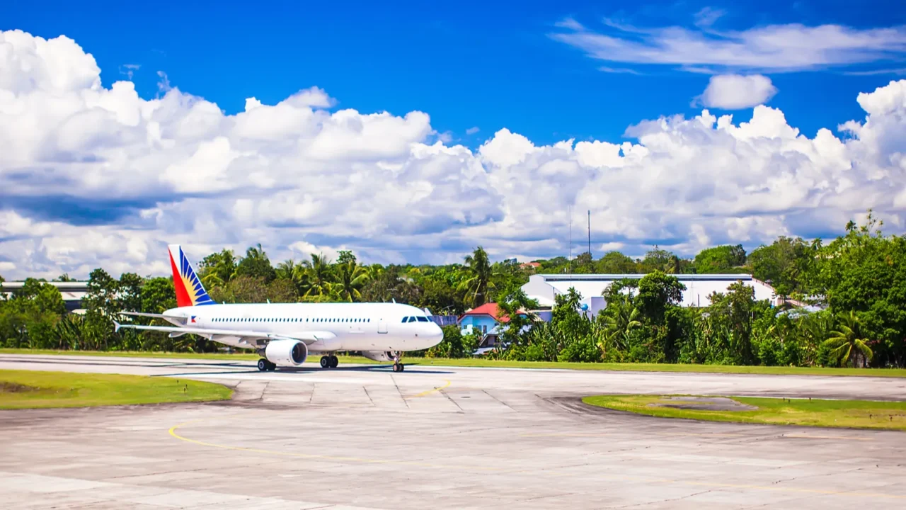 big plane is landing in a small airport on the